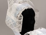 a close up of a mannequin head with a veil on it