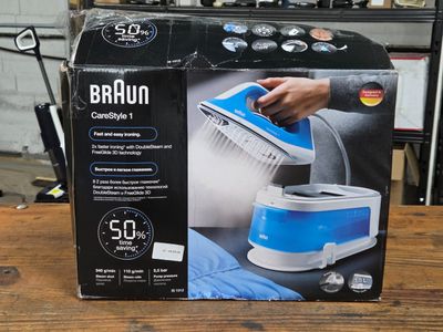 a box that has a blue and white steam iron in it