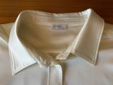 a close up of a white shirt with a label on it