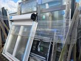 many different types of windows stacked on a pallet