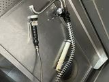 a hose that is attached to the wall in the bathroom