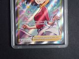 a picture of a pokemon card with a girl in a red shirt