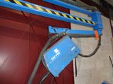 a blue scissor that is attached to a red door