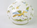 a white vase with a bird design on it