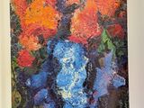 an open book with a painting of flowers in a vase on a table