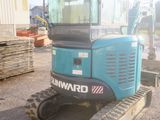 a small blue machine that is parked in the dirt