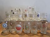 a lot of beer glasses sitting on a table