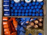 a cardboard box filled with bottles of water and other items