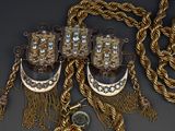 several pieces of jewelry are displayed on a table with a coin