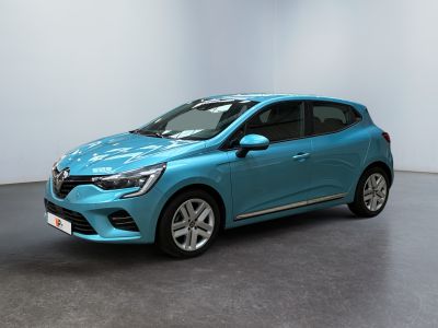 a blue car is parked in a room with a white wall