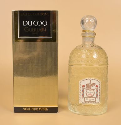 perfume bottle in front of a box and box on a beige background