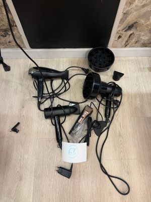 a bunch of hair dryers that are on the floor