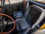 a yellow car with black seats and a steering wheel