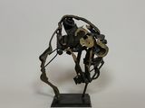 sculpture of a horse made out of metal parts on a white surface