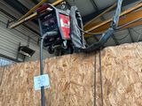 a small portable generator on top of a wooden wall
