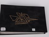 an image of a black book with a gold design on it