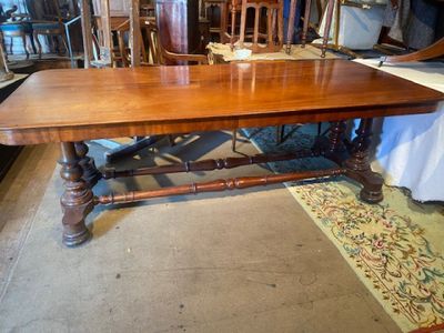 a large wooden table with many chairs around it