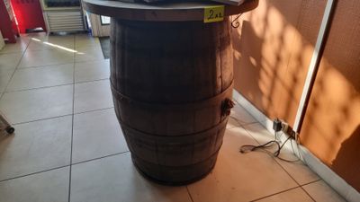 a laptop on top of a barrel on the floor