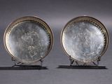 pair of antique silver plate on stand on grey background