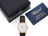 a black and gold watch with a white face and black leather strap