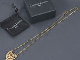 a gold necklace with a chain and a black bag