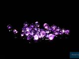 some very pretty purple crystals on a black surface