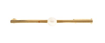 a close up of a gold tie bar with a pearl on it