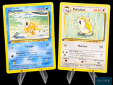 two pokemon cards that are on display on a table