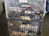 a metal cage filled with assorted items in a warehouse