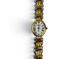 a gold and silver watch with a chain around it
