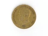 une pièce d'or sur laquelle figure l'image d'un homme