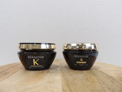 two jars of kerastase hair products sitting on a table