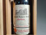 a bottle of wine in a wooden box with writing on it