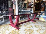 a red table with a glass top in a room