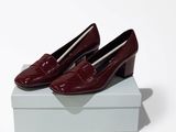 a pair of red shoes sitting on top of a white box