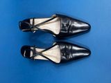 a pair of black shoes on a blue surface