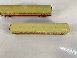 two toy trains sitting side by side on a table