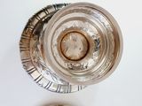 a silver plate and a silver bowl on a white table