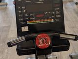 a tread machine in the middle of a gym room