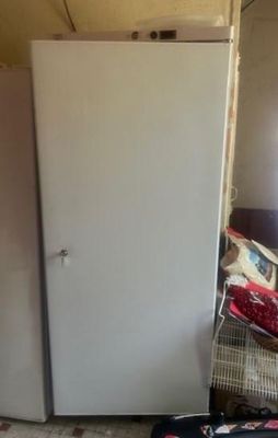 a refrigerator that is sitting in the corner of a room