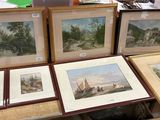 a lot of framed pictures on a table in a room