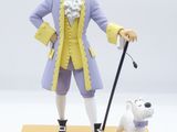 figurine of a man with a cane and a dog on a stand