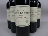 several bottles of wine are lined up on a table