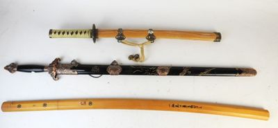 three different types of japanese swords are displayed on a white surface