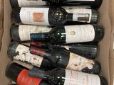 many bottles of wine in a cardboard box on a table