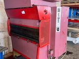a pink machine that is sitting in a warehouse