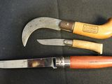 two different types of knives on a black surface