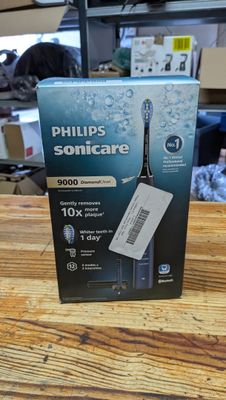 emballage d'une brosse à dents électrique Philips Sonicare posé sur une table en bois