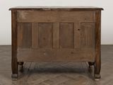 an old wooden chest on a parquet floor