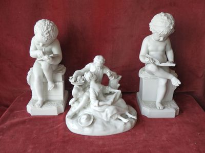 three statues of children sitting on stools on a red cloth